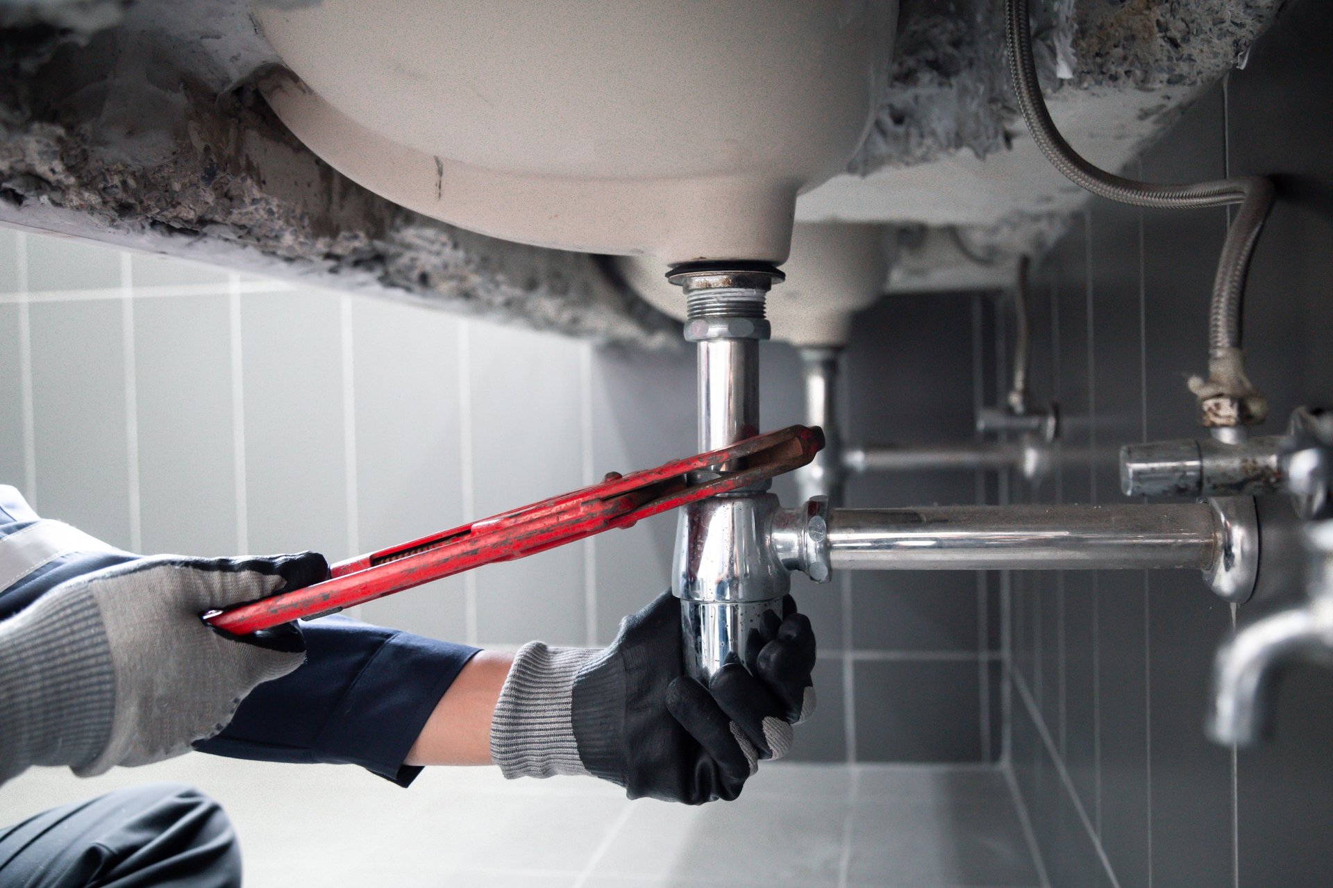 Plumber repairing shower faucet